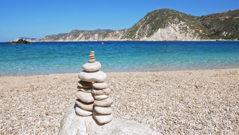 Rock-balancing,-stone-stacks-on-the-beach-of-Agia-Eleni-in-Greece---static-shot