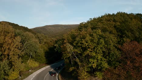 Aerial-ascending-drone-reveal-footage-of-a-mountain-road-in-autumn