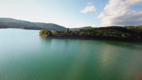 Cinematic-and-dynamic-aerial-drone-footage-of-a-beautiful-teal-coloured-lake-Starina-in-National-Park-Poloniny