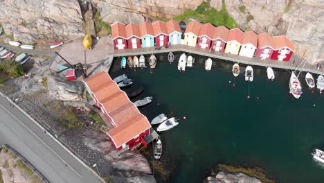 Smooth-drone-aerial-flight-from-right-to-left-with-view-of-small-marina-with-yachts-at-Smogen,-Bohuslan-in-Sweden