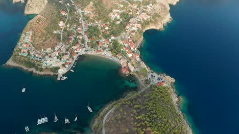 Top-down-view-flyover-Scenic-Assos-village,-stunning-shore-Landscape,-Kefalonia,-Greece