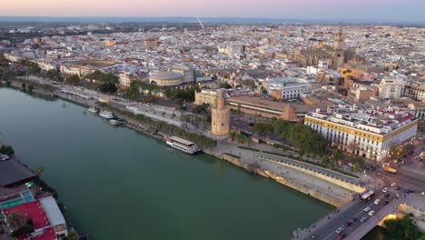 Torre-del-Oro-or-Golden-Tower,-dodecagonal-military-watchtower-in-Seville-Spain-aerial-drone-shot-view