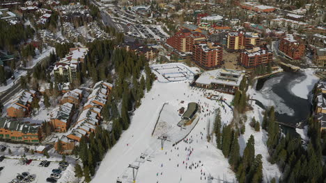 Aerial-drone-footage-of-the-Quicksilver-Super-Chairlift-along-with-skiers-and-snowboarders-in-Breckenridge,-Colorado