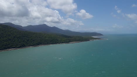 Aerial-View-Of-Calm-Blue-Sea-With-Daintree-National-Park-In-Cape-Tribulation,-Australia