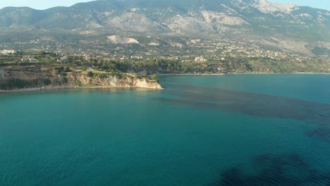 Aerial-Flying-towards-mesmerizing-isolated-house-on-Cliff-edge,-Greek-Island-Landscape