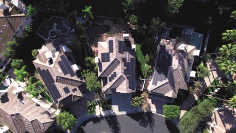 Aerial-Birdseye,-over-multiple-houses,-solar-panels-on-roof,-in-private-neighborhood-of-Calabasas