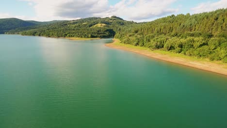 Cinematic-drone-footage-of-a-beautiful-teal-coloured-lake-Starina-in-National-Park-Poloniny