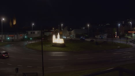 Night-Scene-At-The-Trafalgar-Roundabout-In-Truro,-Cornwall-With-Miniature-Cathedral-And-Christmas-Lights-Decoration