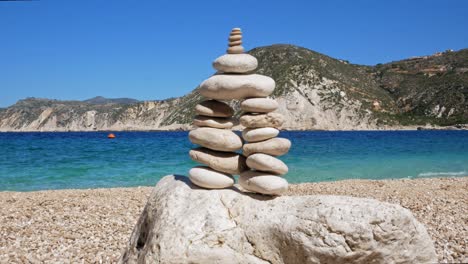 Stone-pebble-tower-balancing-on-the-beach-in-Agia-Eleni,-Greece---close-up