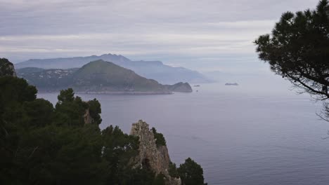 Wide-view-of-Sorrento-and-Amalfi-coast-from-Capri-during-a-cloudy-day,-Timelapse