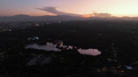 Lake-Lago-Mayor-de-Chapultepec,-vibrant-sundown-in-Mexico-city---Aerial-overview