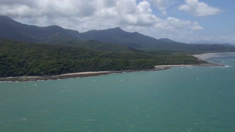 Daintree-National-Park,-Remote-Beach-And-Blue-Sea-With-Mountain-Views-At-Cape-Tribulation,-QLD,-Australia
