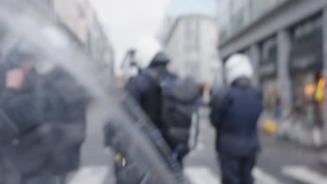 POV-shot-of-protester-trying-to-slip-through-police-security