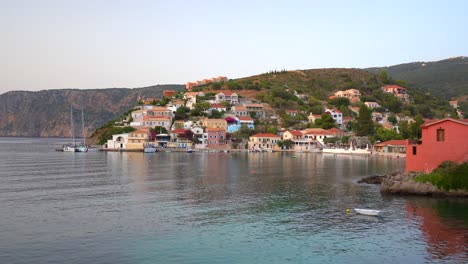 Seascape-view,-picturesque-Assos-colorful-village-by-the-sea-during-sunset,-Kefalonia-Island