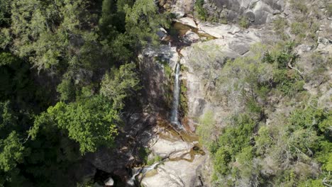 Visitors-enjoying-the-crystal-clear-and-warm-waters-of-Fecha-de-Barjas-waterfall,-Peneda-Gerês-National-Park,-Portugal