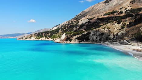 Sandy-Beach-And-Scenic-Cliffs-At-Agia-Kiriaki-In-Greece---aerial-drone-shot
