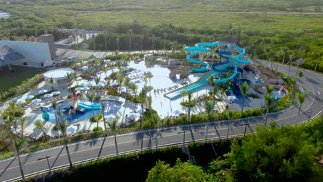Water-slide-park-in-tropical-resort,-luxury-family-hotel-in-Dominican-Republic,-aerial-view-of-aqua-park