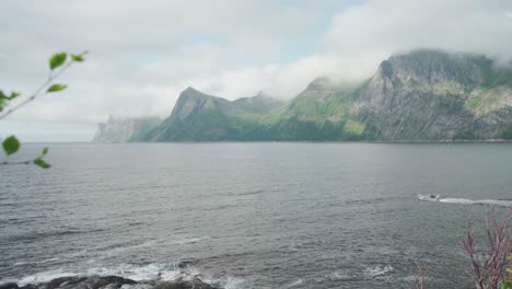 Speedboat-Cruising-in-the-Ocean-With-Mountains-In-Background-In-Senja,-Norway