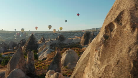 Hot-Air-Balloon-Festival-flying-over-Goreme,-town-in-Cappadocia,-Turkey