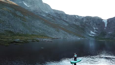 Young-Woman-on-Paddle-Board-in-Alpine-Lake-Under-Mount-Evans-Byway