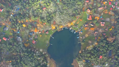 Aerial-top-down-view-of-autumnal-lake-near-Stockholm,-swedish-destination-overhead-drone-shot