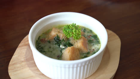 spinach-soup-with-bread-in-white-bowl