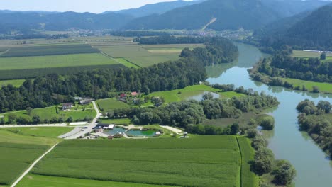 Aerial-View-Slovenia-countryside-with-Vodni-Park-center-and-Drava-River-to-the-right,-Drone-approach-fly-over-reveal-shot