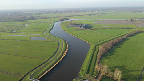 Aerial-of-a-beautiful-farm-in-Dutch-countryside---drone-flying-backwards