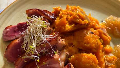 Delicious-duck-breast-with-pumpkin-puree,-ginger-jam-and-green-sprouts,-traditional-french-cuisine,-4K-shot