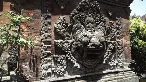 This-is-in-Ubud-palace,-mythology-animal-face-on-the-wall-with-the-flowers