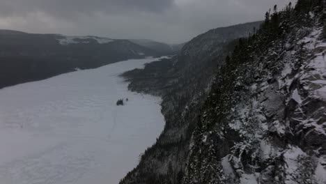 Drone-Flight-Around-Mont-du-Lac-a-L'Empeche-In-Quebec,-Canada-During-Winter---aerial-shot