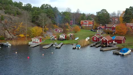 Picturesque-wooden-cabins-in-a-lake-near-Sockholm-baltic-sea-drone-landscape