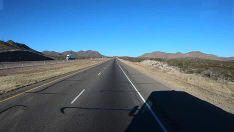 POV-While-driving-along-the-Interstate-with-only-oncoming-traffic-in-New-Mexico-on-a-sunny-day
