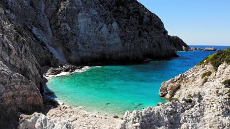 Turquoise-Lagoon-And-Coastal-Cliffs---Agia-Eleni-Beach-In-Greece---aerial-pullback