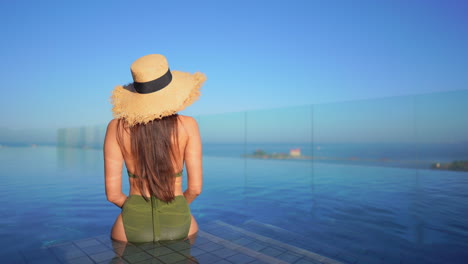 An-attractive-woman-relaxing-in-an-infinity-pool-at-a-luxury-hotel-and-spa