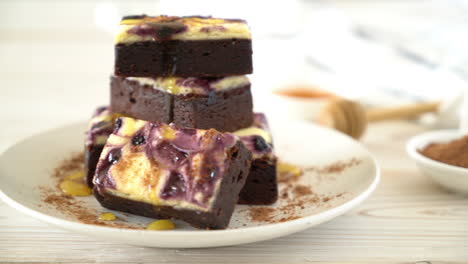 blueberry-cheese-brownies-cake-on-wooden-board-with-honey