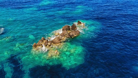 Turquoise-Ocean-And-Rocks-At-Agia-Eleni-Beach-In-Greece---aerial-static