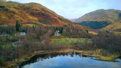 Aerial-shot-flying-in-from-loch-to-church,-Scotland