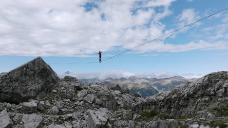 Aerial-shot-of-Highliner-Walking-In-A-Tight-Rope-and-falling-down-in-mountains