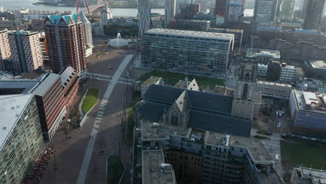 Cityscape-With-Markthal-Building-And-Laurenskerk-Church-In-Rotterdam,-Netherlands---aerial-drone-shot