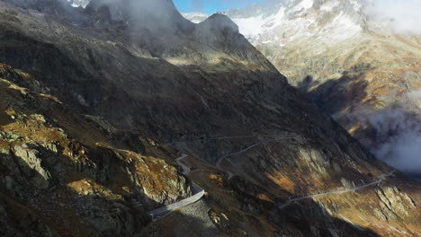 Cinematic-rotating-aerial-footage-of-Susten-Pass-in-the-Swiss-Alps-in-Switzerland-with-snow-on-the-peaks