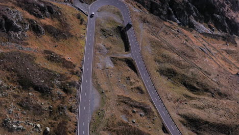 Downward-angle-drone-footage-of-a-hairpin-turn-and-vehicles-on-the-Susten-Pass-in-the-Swiss-Alps-in-Switzerland