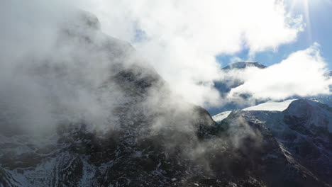 Cinematic-drone-footage-of-the-cloudy-Swiss-Alps-in-Switzerland-with-snow-on-the-peaks