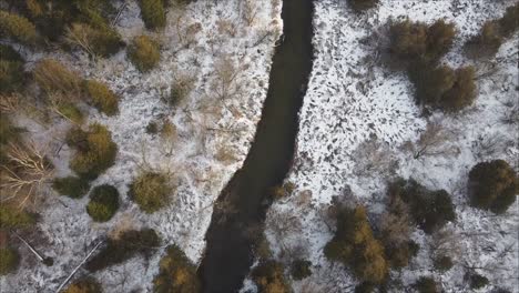 Aerial-Shot-Of-A-River-In-A-Pristine-Winter-Forest-Landscape-Scene