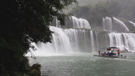 People-getting-closer-to-the-biggest-waterfall-of-Ban-Gioc,-Vietnam-also-known-as-Detian-in-China,-near-the-border-between-North-Vietnam-and-South-China