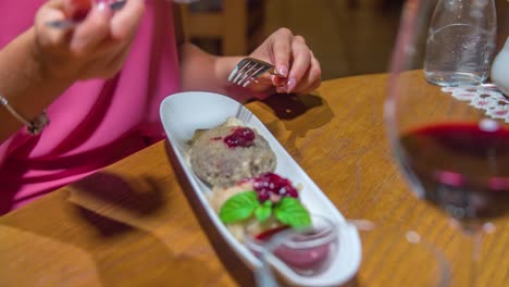 Close-up-dessert-at-restaurant,-Caucasian-female-hands-putting-dessert-on-spoon,-Static-shot