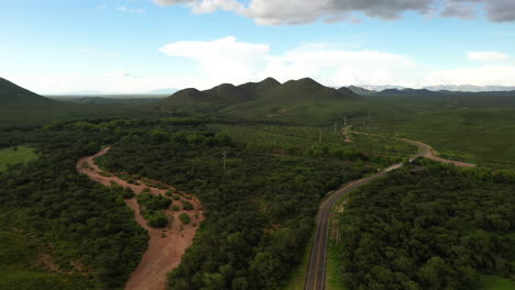 Sierra-Vista-Arizona-highway-through-nature-preserve,-drone-backwards