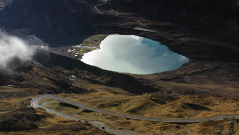 Cinematic-rotating-drone-shot-of-the-Steinsee-Lake-along-the-Susten-Pass,-Switzerland