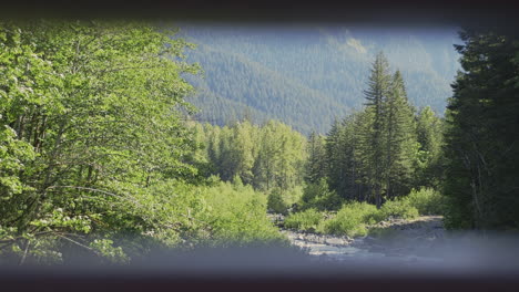 Wide-Shot-dolly-out-to-frame-within-frame-of-a-river-and-mountain-landscape