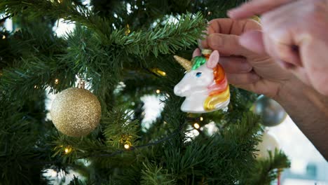 Hanging-colorful-unicorn-head-decoration-on-artificial-christmas-tree
